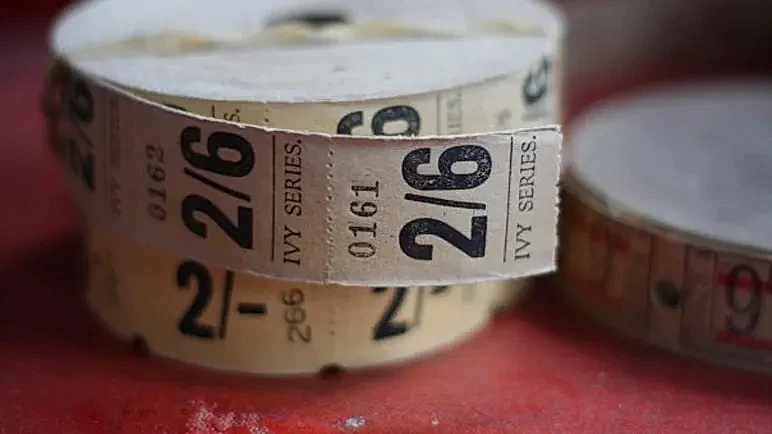 A close-up of a roll of 'Ivy Series' cinema tickets showing a price of 2/6.