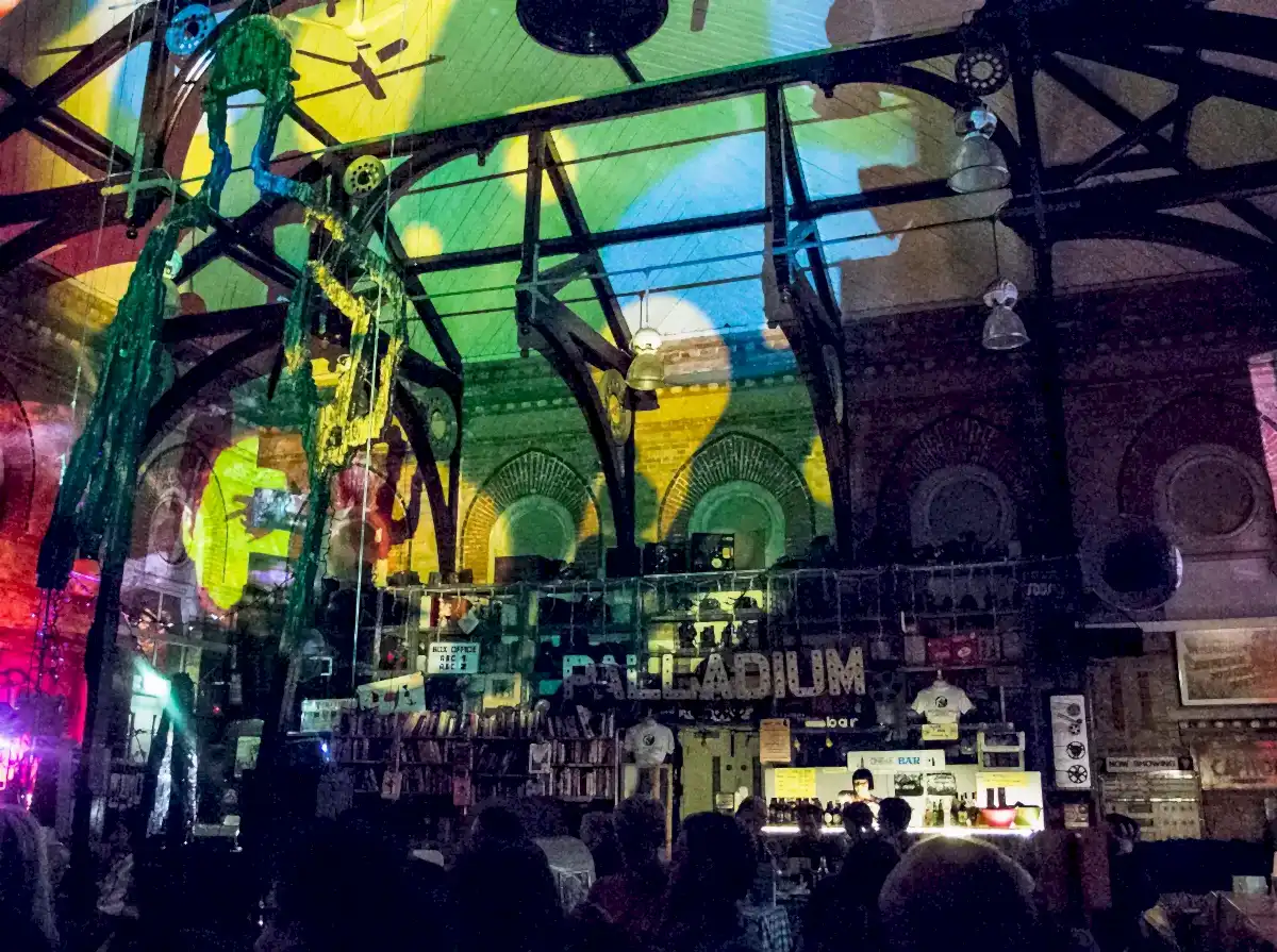 The main hall of the Museum during an event - the ceiling is bathed in coloured lights.